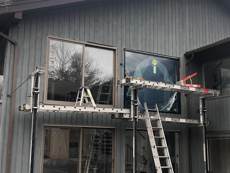 New Pella picture window in comparison with the old brown door